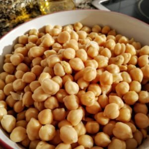 A large bowl of cooked chickpeas sits in a Spanish kitchen