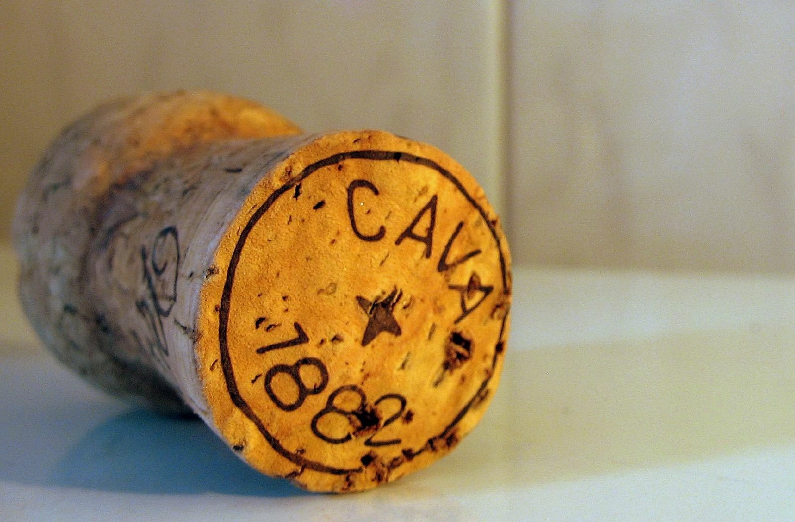 A cork from a cava bottle sits on a counter top