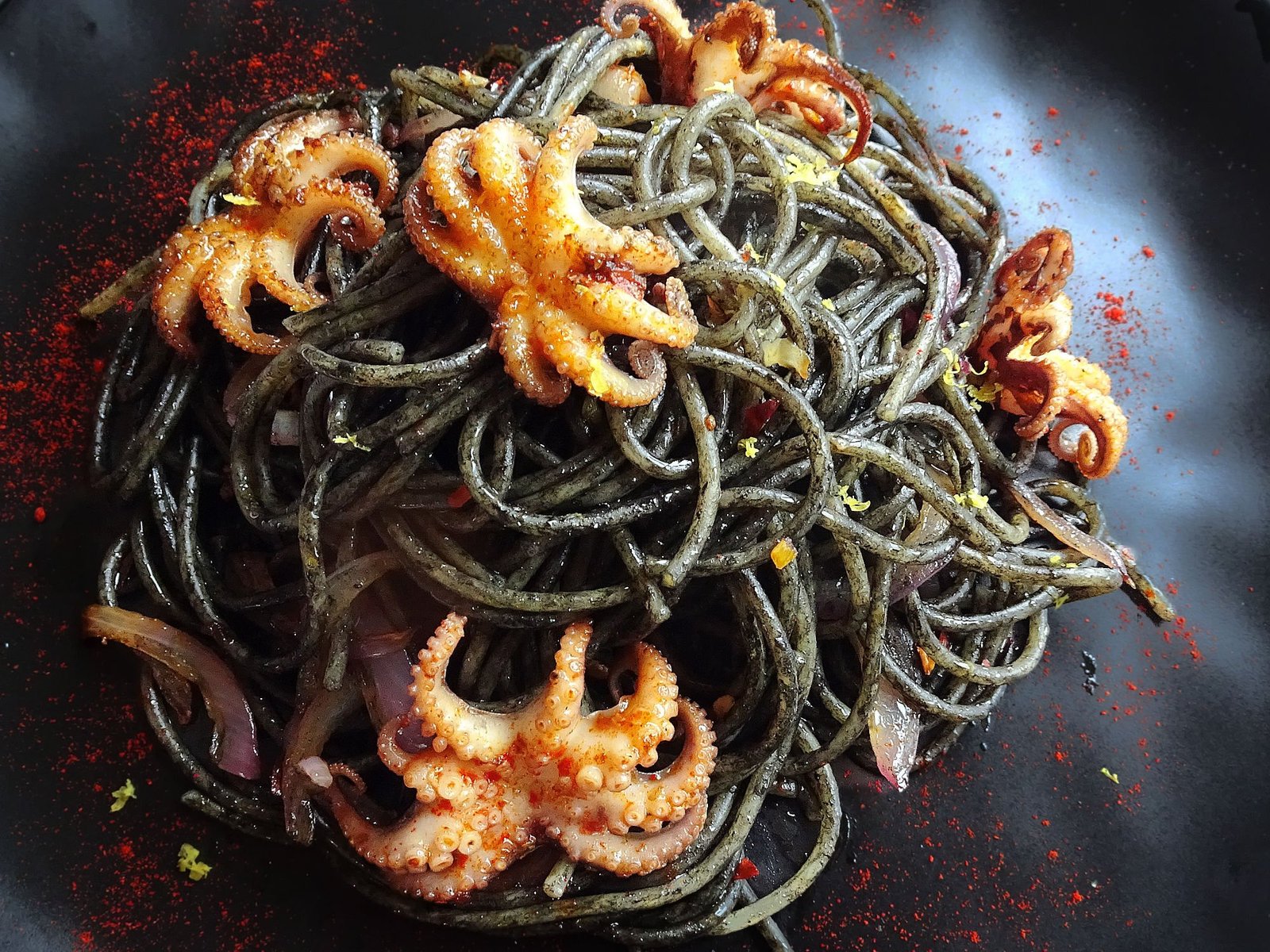 A plate of Squid ink pasta with baby squid