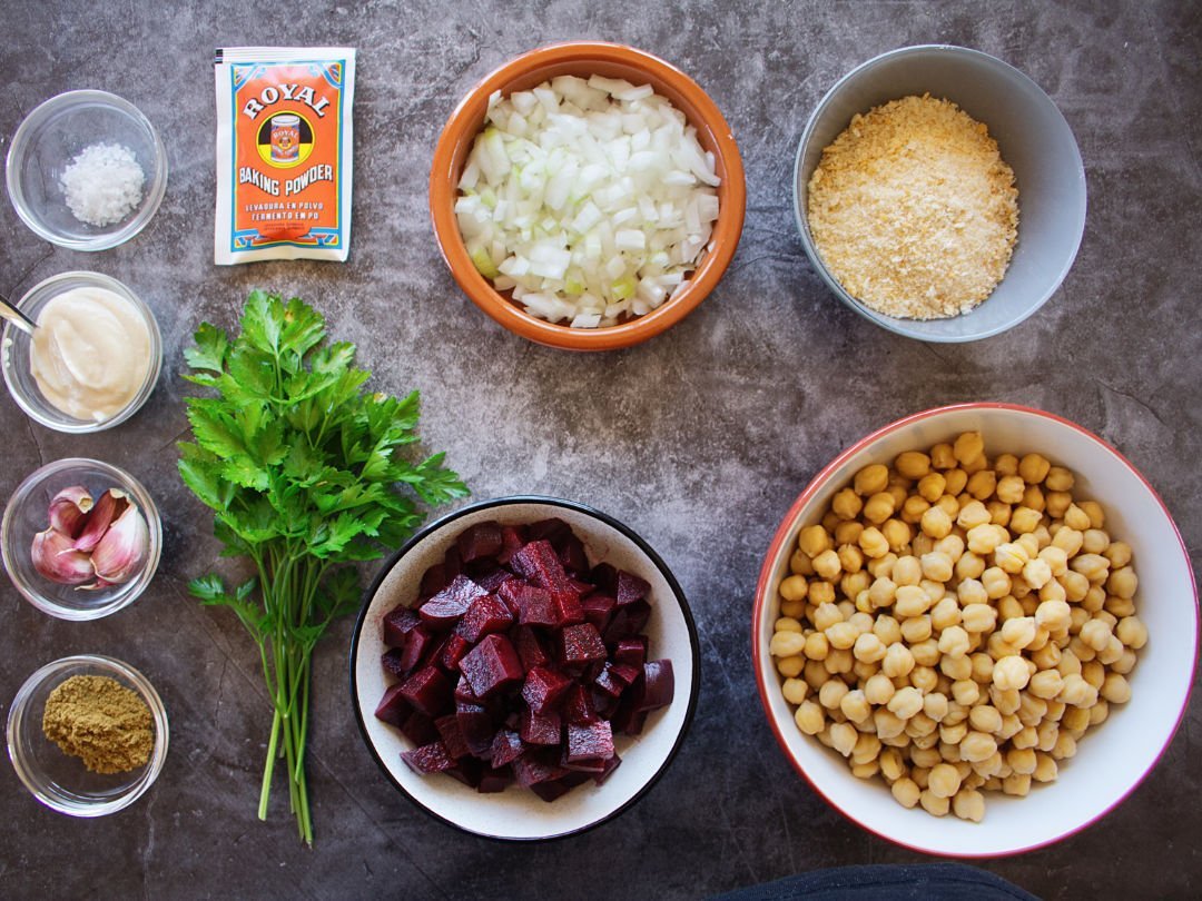 Ingedients for making this beetroot falafel recipe are laid out on a stone countertop