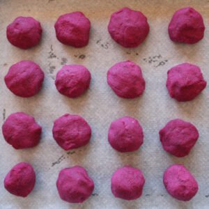 pre baked beetroot falafel balls sits on some parchement paper in an oven tray