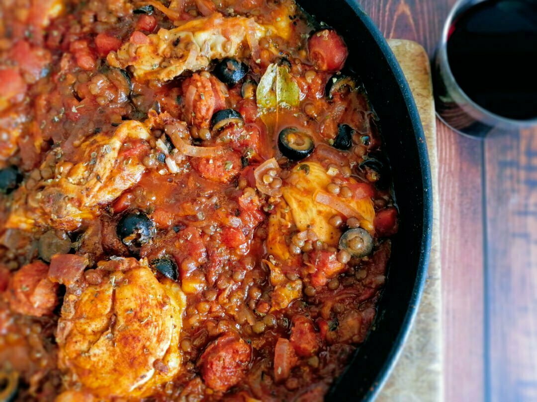 A close up shot of a pan full of chicken and chorizo stew