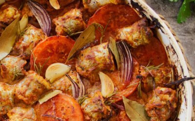Oven baked fish casserole in romesco sauce and garlic