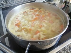 a large pan of boiled potatoes and carrots