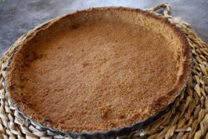 a baked biscuit pie base sits on a counter