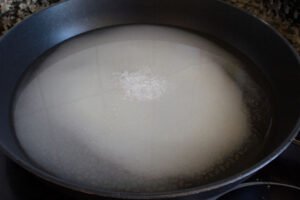 water, sugar, and salt slowly dissolves in a frying pan