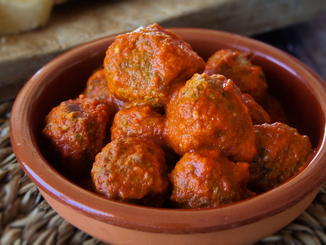albondigas-hero-full-1080x820 A small ceramic bowl of Albondigas sits in a rich sofrito sauce waiting to be served