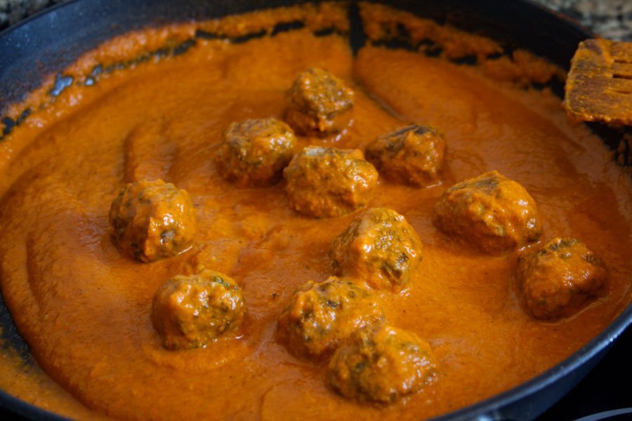 albondigas simmer in a sofrito sauce in a frying pan
