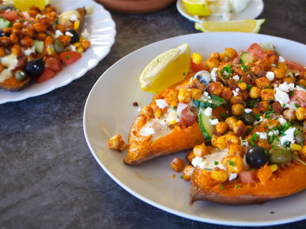 medsweetpotatoesherov11200x900 - The Spanish Radish A plate of Mediterranean baked sweet potatoes loaded up with toppings and a white yogurt sauce