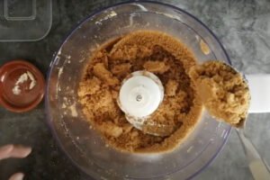 Butter is added to the biscuits in a food processor