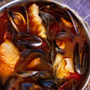 A pot of Mediterranean fish stew Zarzuela de Mariscos with mussels and fish in a broth