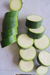 sliced zucchini sits on a chopping board