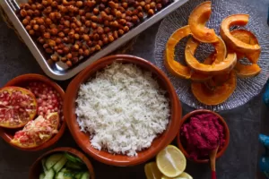 Ingredients for making a Mediterranean rice bowl are laid out on a counter