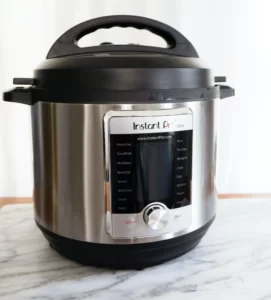 a rice cooker sits on a marble counter top