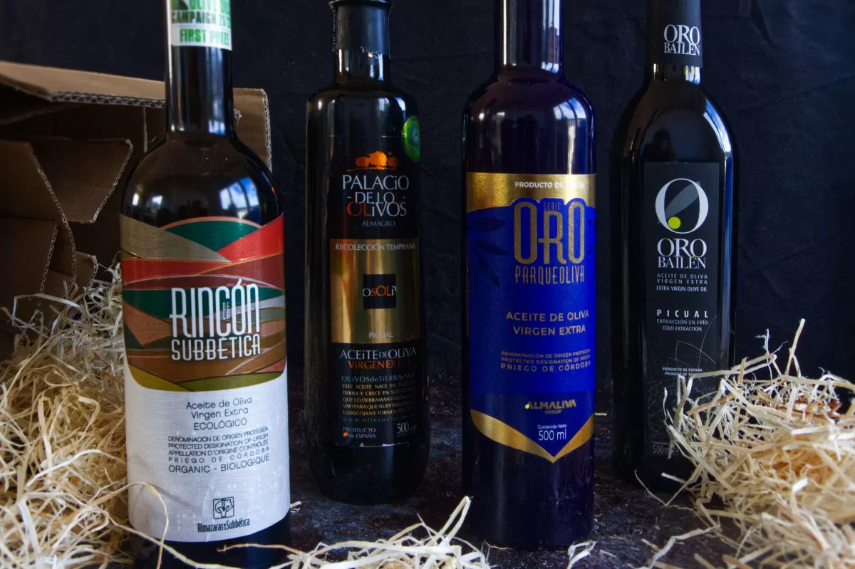 4 award-winning bbottles of extra virgin olive oil arranged on a counter.