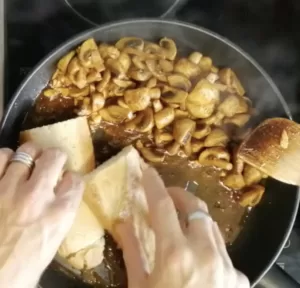 Some breadd fires beside cooked garlic mushrooms