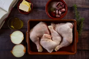 ingredients for making pollo al horno are laid on a wooden counter top