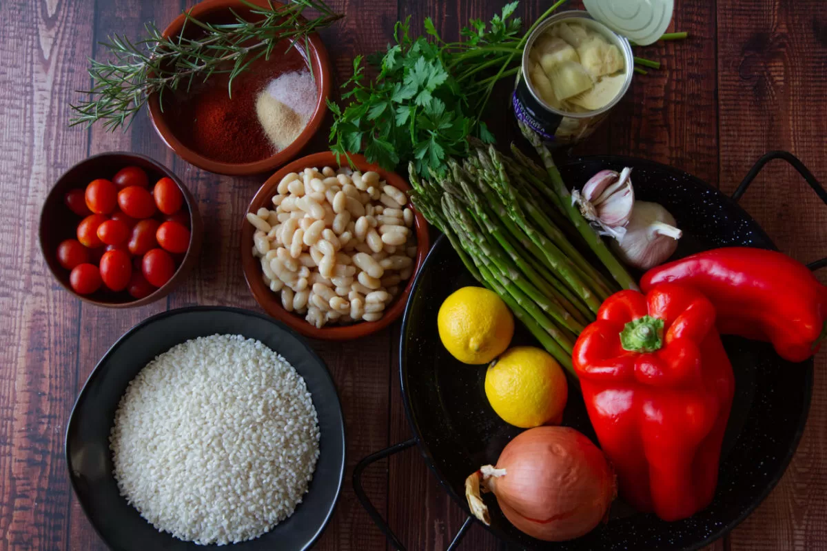 ingredients for making vegan oven bbaked rice are laid out on a wooden table