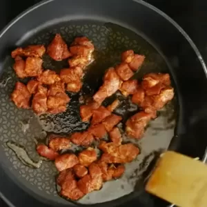 cooked pork pieces in a frying pan