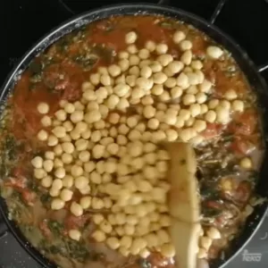 Chickpeas are added to pan