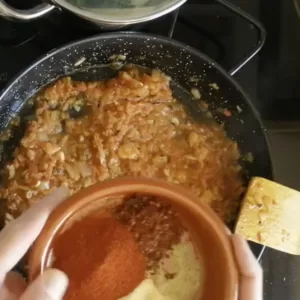Spices are added to a suteed sofrito sauce