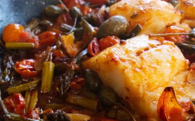 Oven-baked cod fish with asparagus and cherry tomatoes
