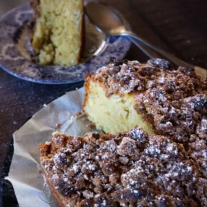 A large Apple cake with a slice taken out of it.