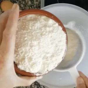 flour is sievved into a mixing bowl