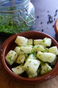 A small bowl of pan fried squid with green sauce