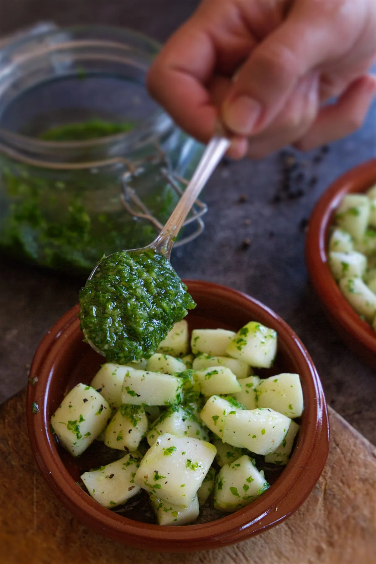 A small tapas serving of pan-fried squid with some green garlic and parsley sauce spooned on top. 