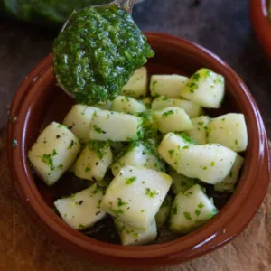 A small bowl of pan fried squid with green sauce