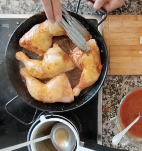 browned chicken pieces in a pan.