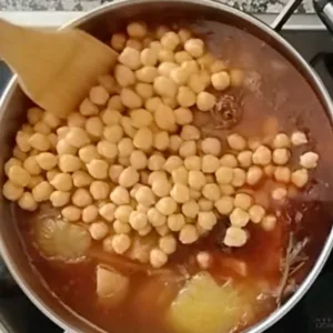 Chickpeas are added to the stew.