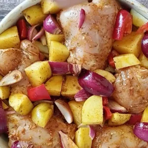 chicken thighs and potatoes in a marinade.