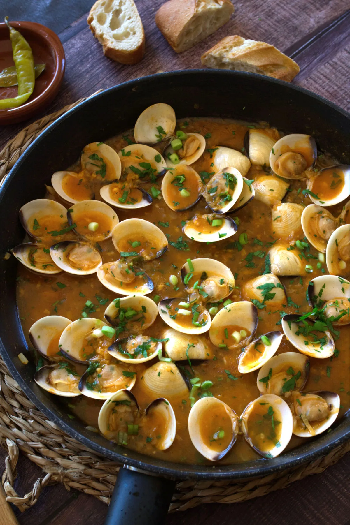 A large pan of Spanish-style clams in tomato and wine.