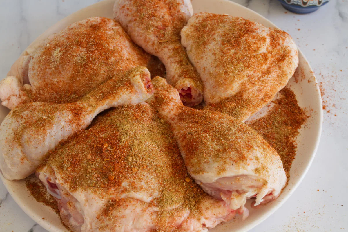 some raw chicken pieces are seasoned with a Mediterranean combination of spices. 