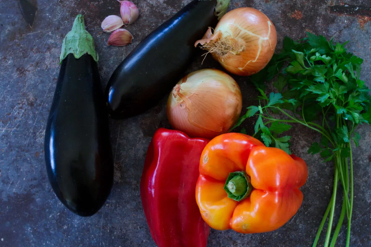 2 eggplants, red bell peppers, onions, parlsey, and garlic.