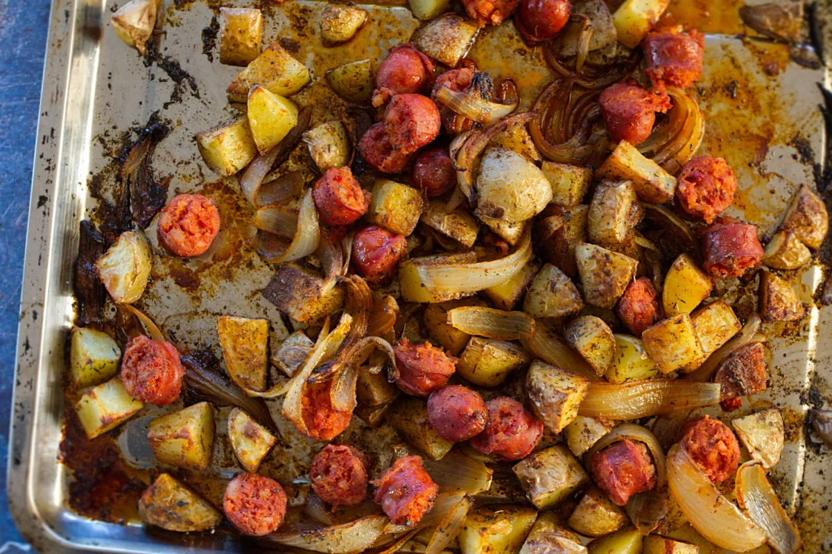 A tray of roasted potatoes with chorizo and thyme.