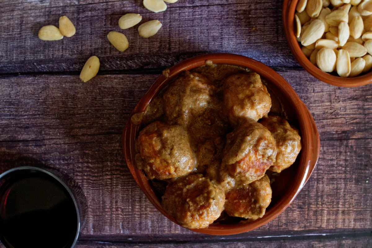 A small tapas serving of chicken meatballs with almond sauce.