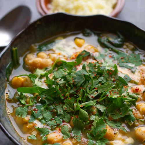 A bowl of spinach and chickpea soup.