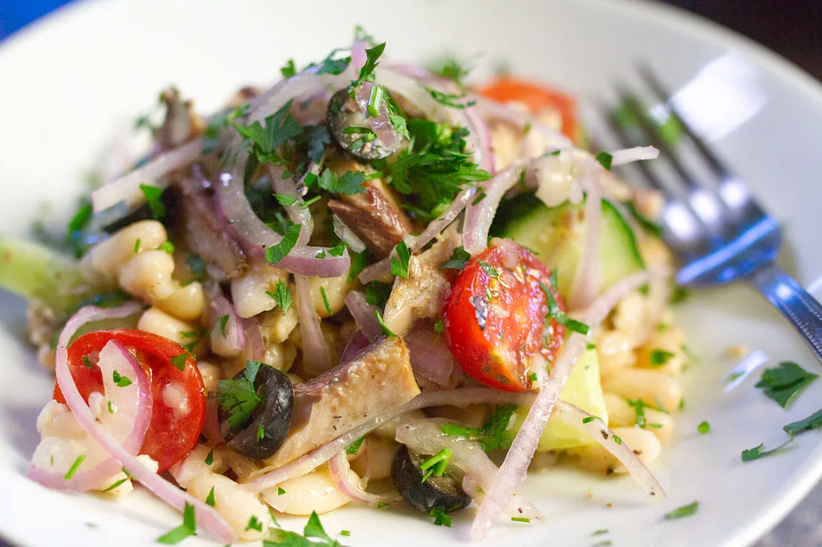 A bowl of white bean salad with sardines