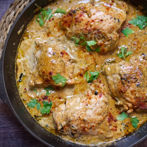 one-skillet creamy chicne thighs with some fresh parsley for garnish