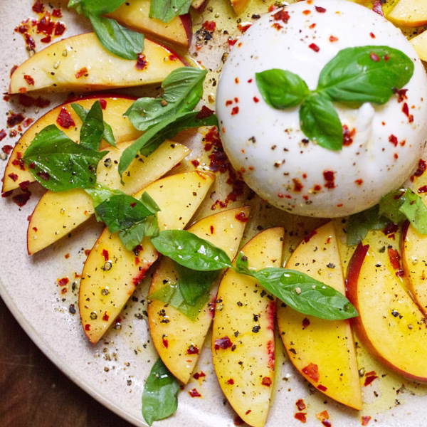 A burrata ball with sliced nectarines