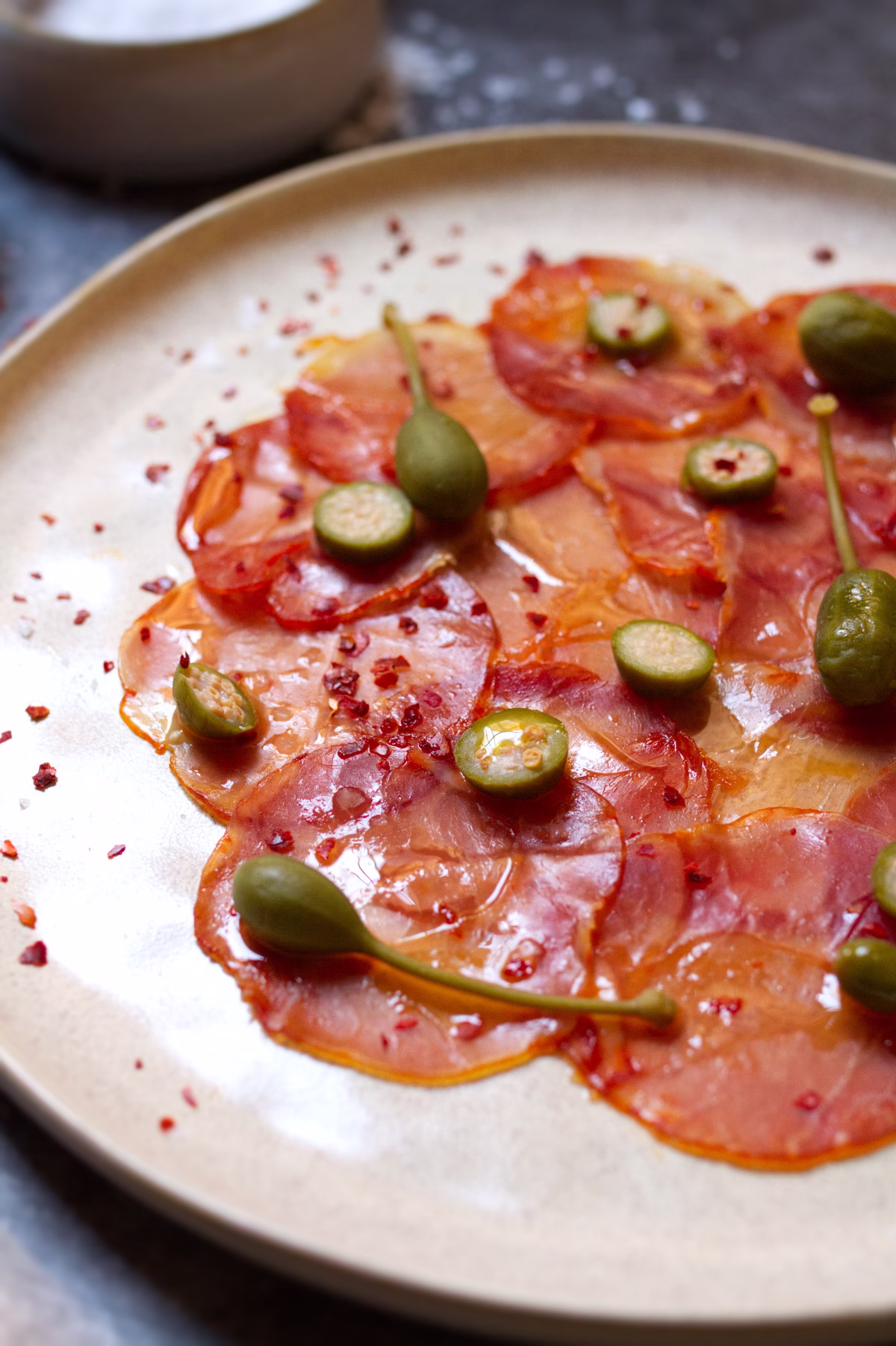 Lomo Iberico with Alcaparras and Nora Pepper-v38 a plate of Lomo Ibérico with Alcaparras & Ñora Pepper