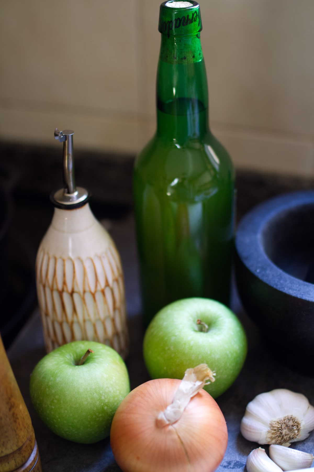 A bottle of Asturian cider and some granny smith apples