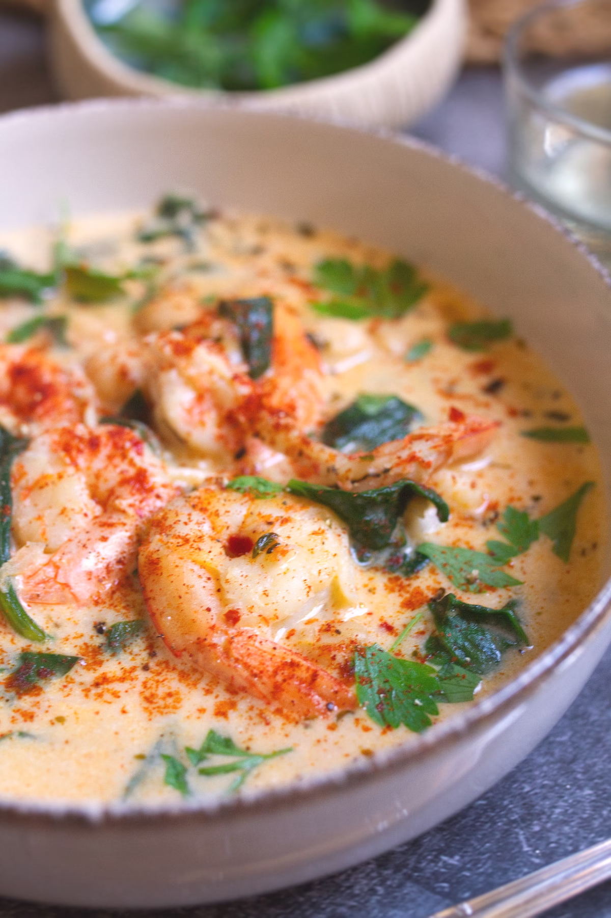 Creamy Shrimp Soup with Spinach Chickpeas-v2 A bowl of creamy shrim soup with spinach and chickpeas is garnished with some fresh parsley