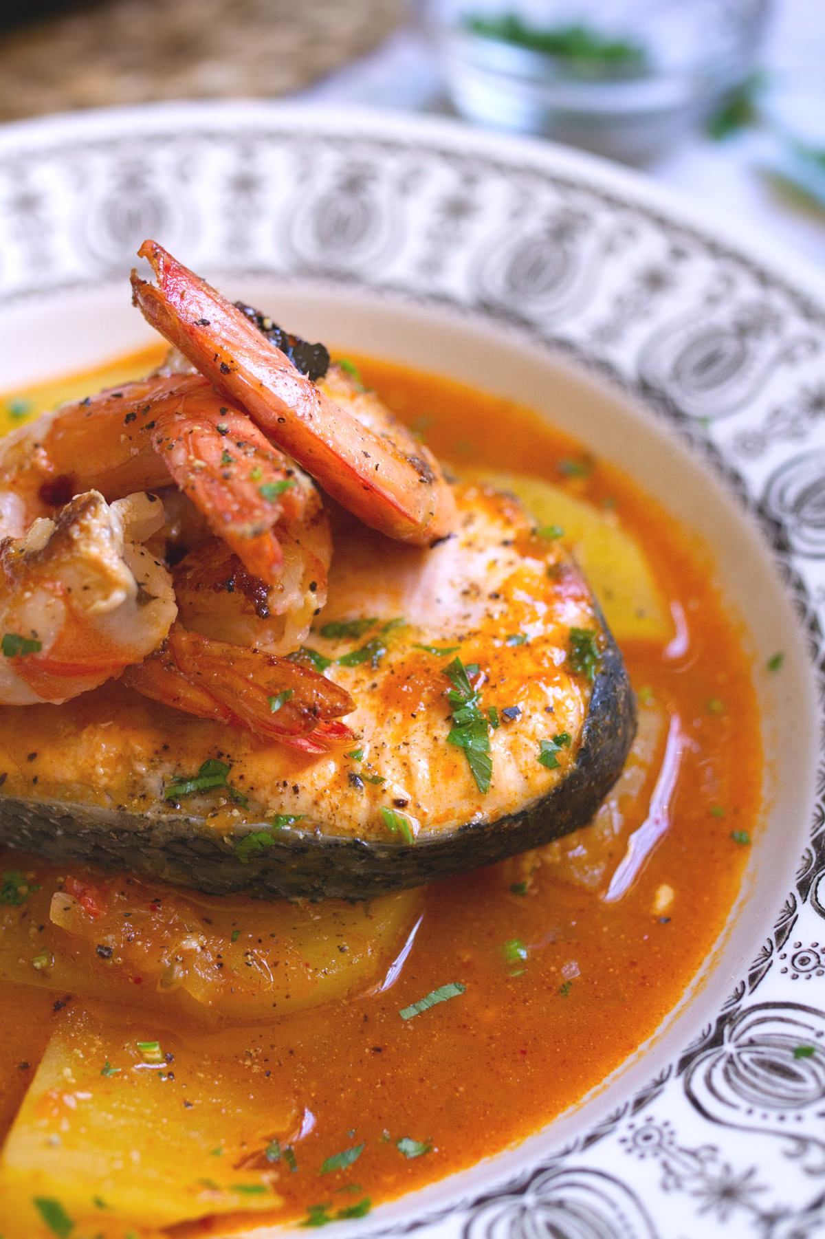 A serving of Spanish salmon stew with a shrimp on top