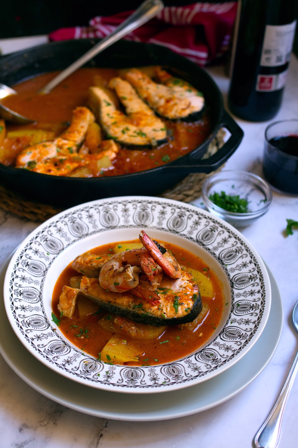 A serving of Spanish salmon stew with a shrimp on top