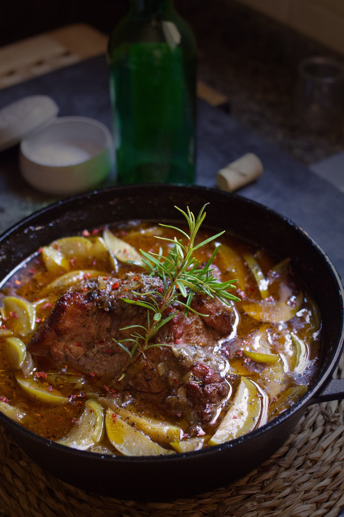 A dutch oven with some braised pork and Asturian cider