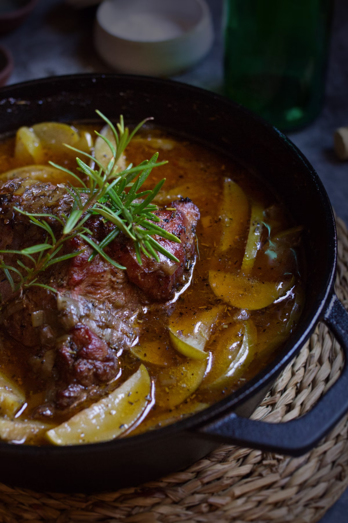 A dutch oven with some braised pork and Asturian cider
